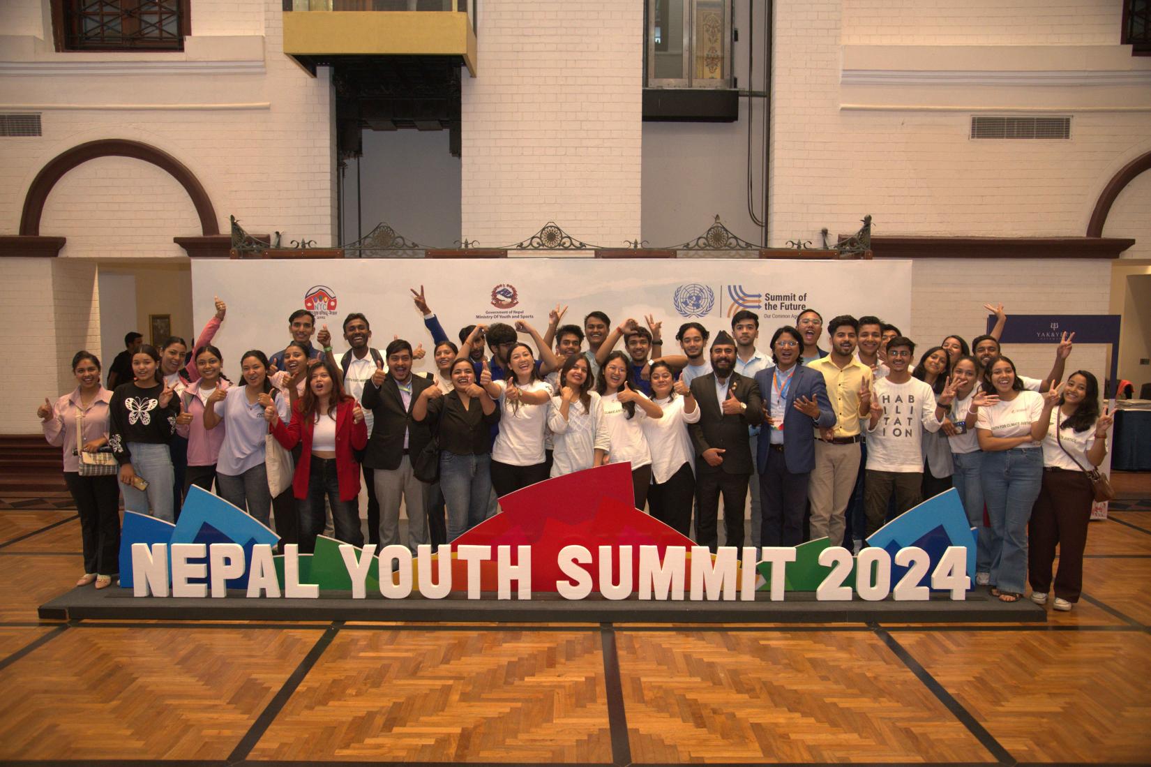 Group of people are posing with thump-up in the Nepal Youth Summit 2024