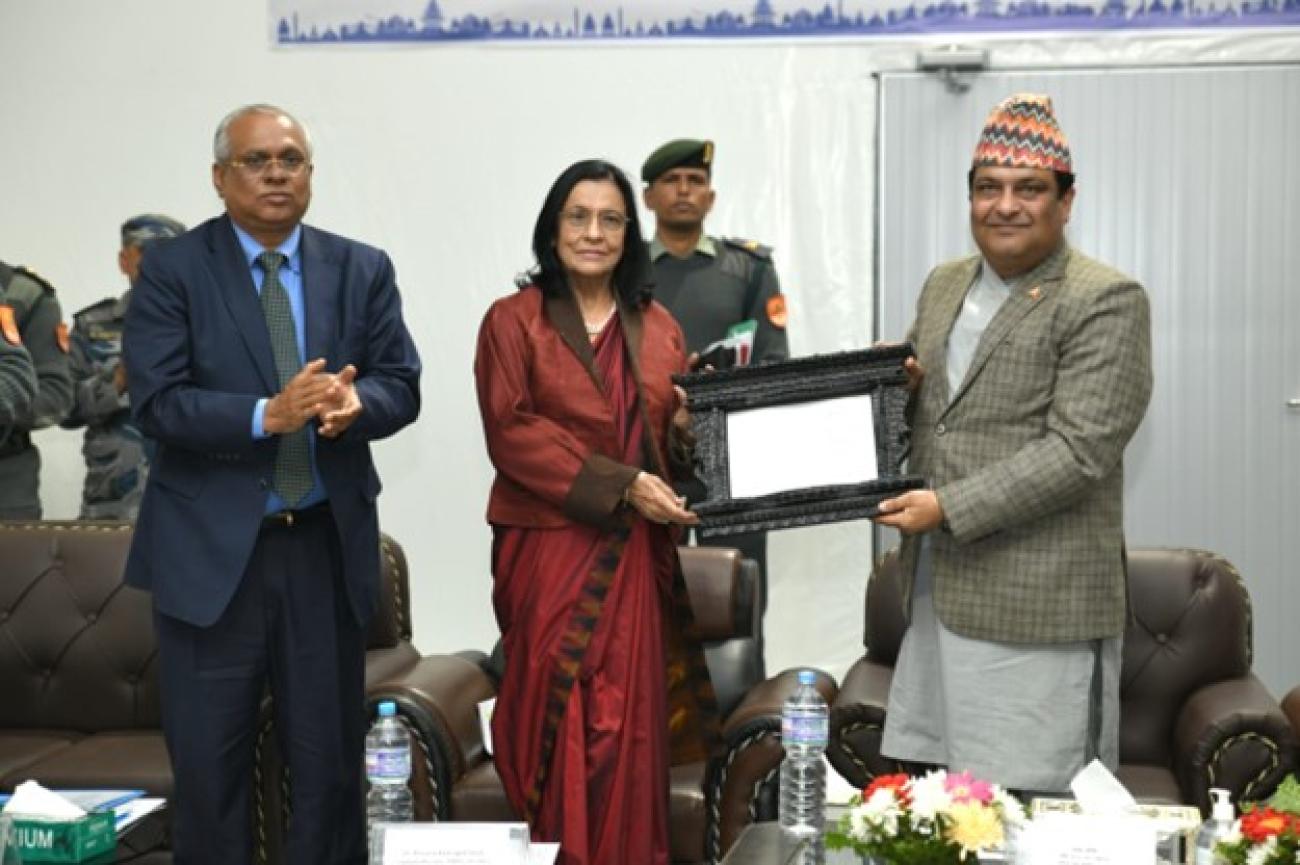 WHO regional director handing out a certificate to Dr Roshan at her left, while Dr. Rajesh stands at her right. Dr Rajesh Sambhajirao Pandav, WHO Representative to Nepal (left) and Dr Poonam Khetrapal Singh, WHO Regional Director for South-East Asia (middle), hand over the Severe Acute Respiratory Infections Treatment Facility to Dr Roshan Pokhrel, Hon'ble Secretary of the Ministry of Health and Population in Nepal.