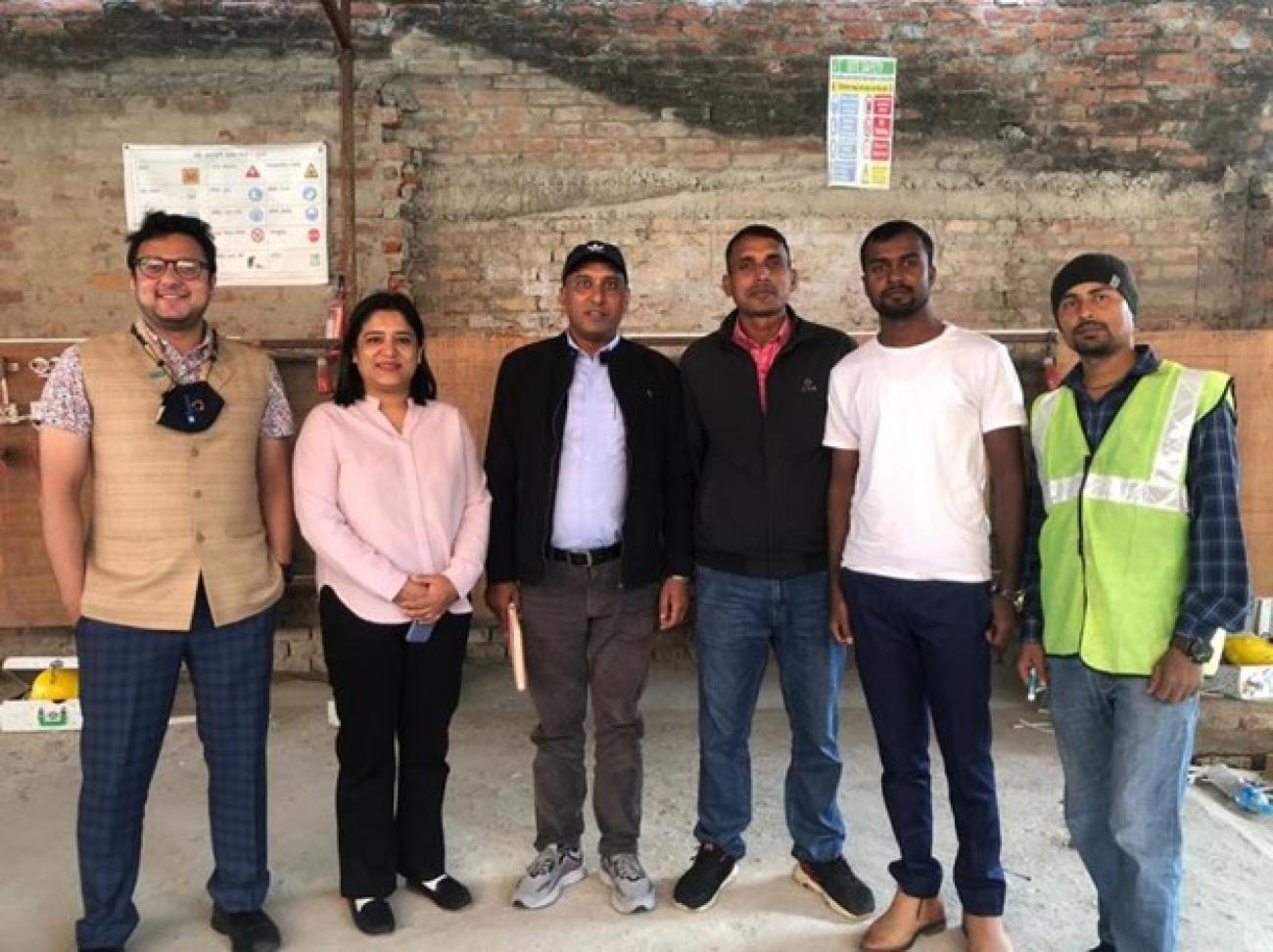 Six people standing side by side smiling to take a picture inside a building.  Rina Pradhan (second from left), national UN Volunteer Programme Assistant with UNV, with fellow volunteers during a field visit in Madhesh Province, Nepal. UNV, 2022