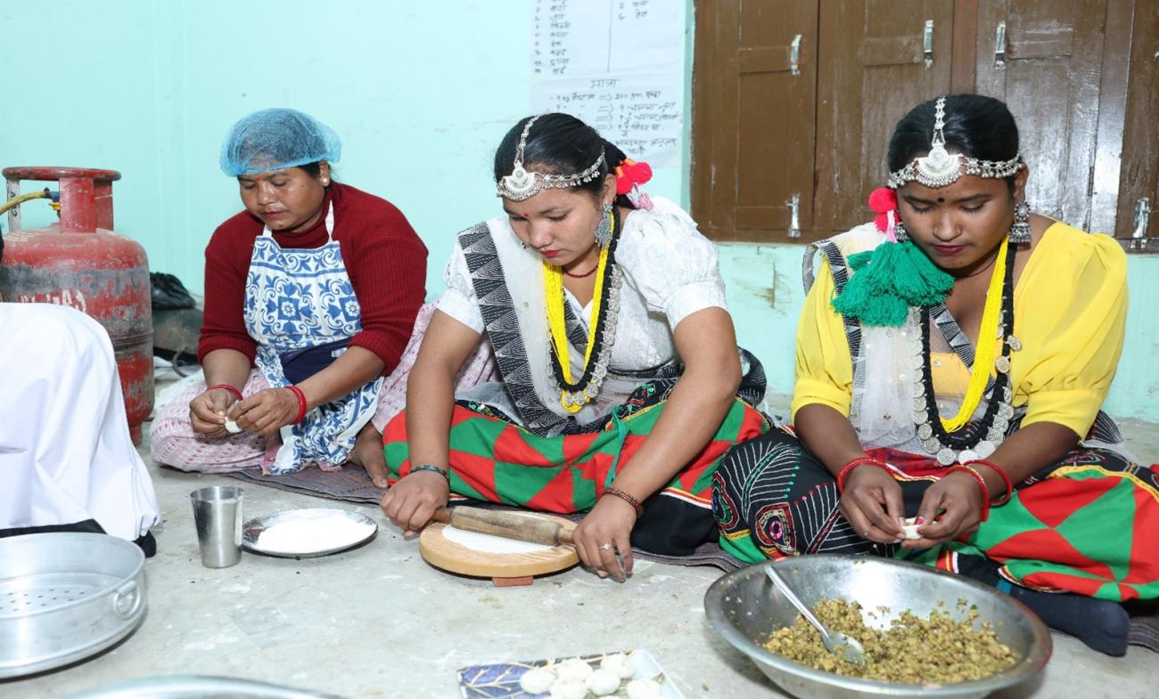 A group of people, some standing and some sitting,