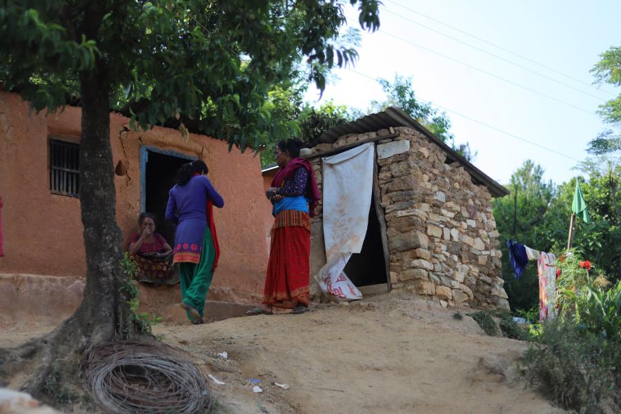 Rama (middle) walking towards her house in Namuna Basti where she lives with her mother(right) and children.