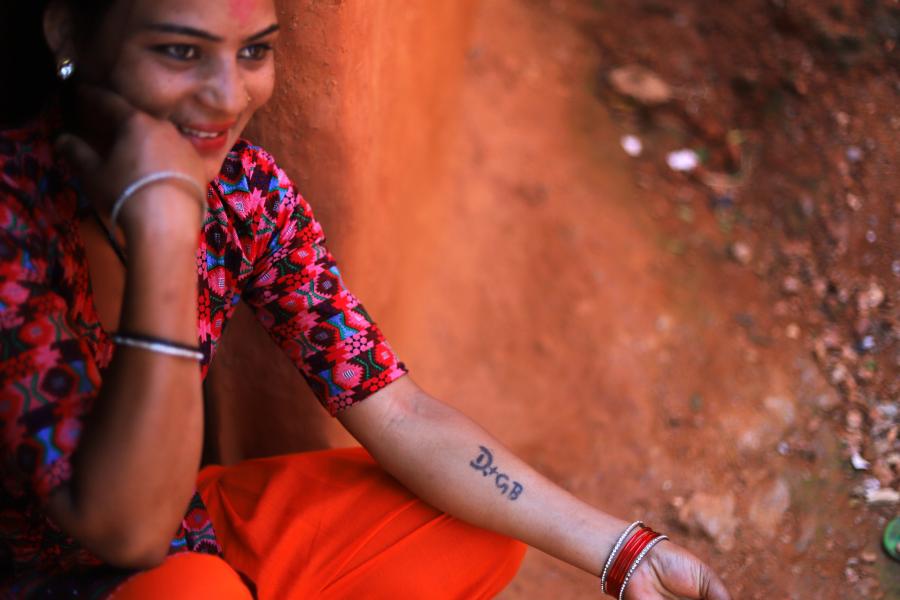 “Together Forever” says Seema with happiness as she shows the initials of her husband and daughter's name inked on her left hand.