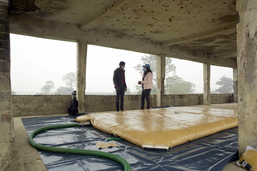 A WFP-supported water bladder, set up in a safe area to store drinking water prior to a flood.
