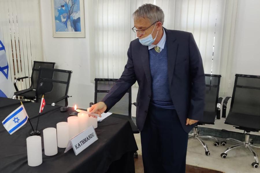His Excellency Mr Hanan Goder Ambassador of Israel lighting six candles in the memory of six million jews perished in Holocaust