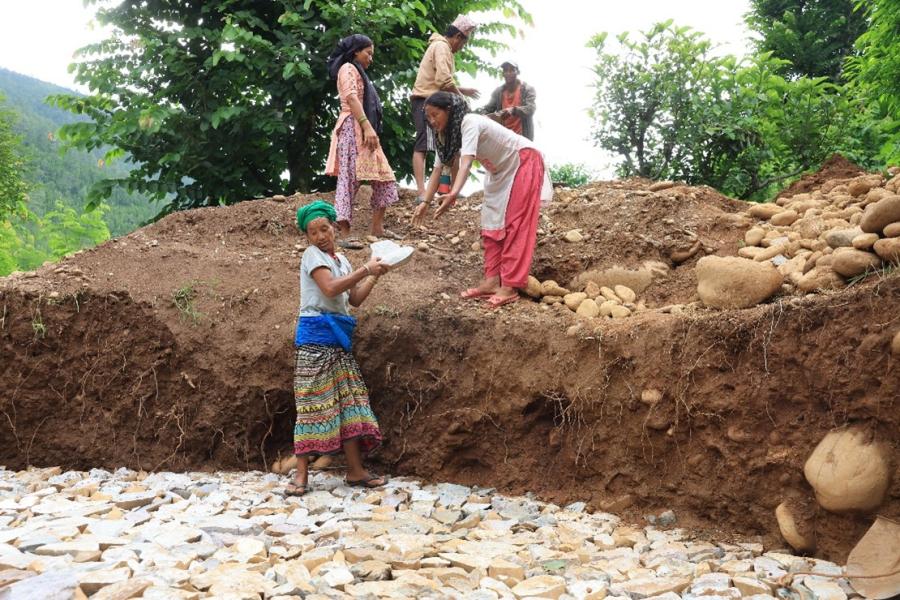 Gaumati and other women working on laying the foundation of the reservoir tank.  