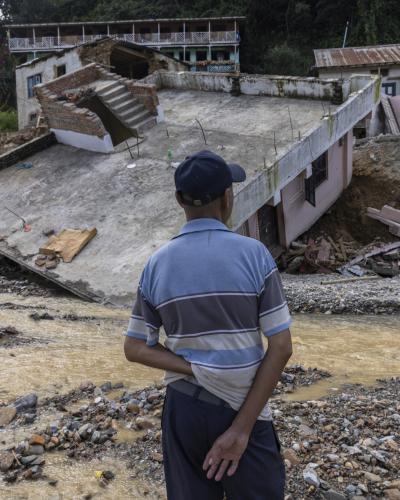 The man in the looking at his damage house due to flood